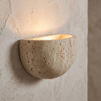 Carved Yellow Travertine Bedside Wall Light, close view at 45 degrees on a plaster wall