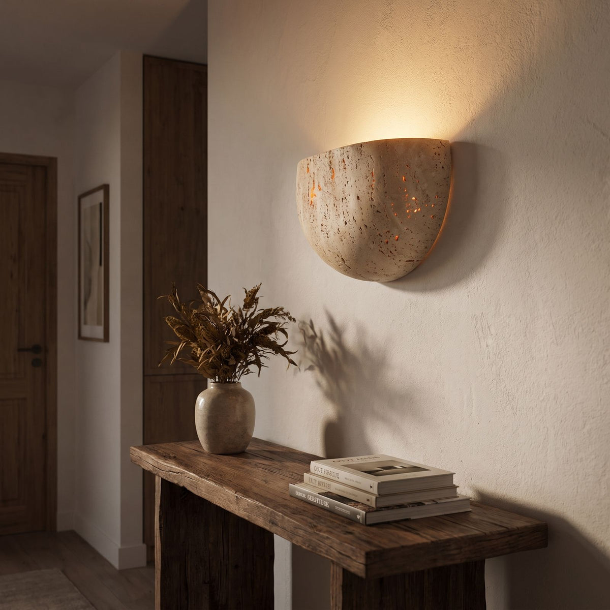 Carved Yellow Travertine Bedside Wall Light in a hallway above a timber console