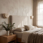 Carved Yellow Travertine Bedside Wall Light in a pair on a wall of an Australian home
