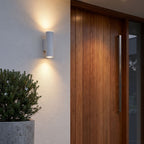 Cement and Acrylic Outdoor Wall Light beside a timber front door on a rendered wall