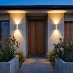 A pair of Cement and Acrylic Outdoor Wall Lights either side of a timber entry door