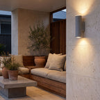 Cement and Acrylic Outdoor Wall Light on a limestone wall in a covered outdoor lounge