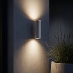 Cement and Acrylic Outdoor Wall Light lighting a dark rendered wall at night