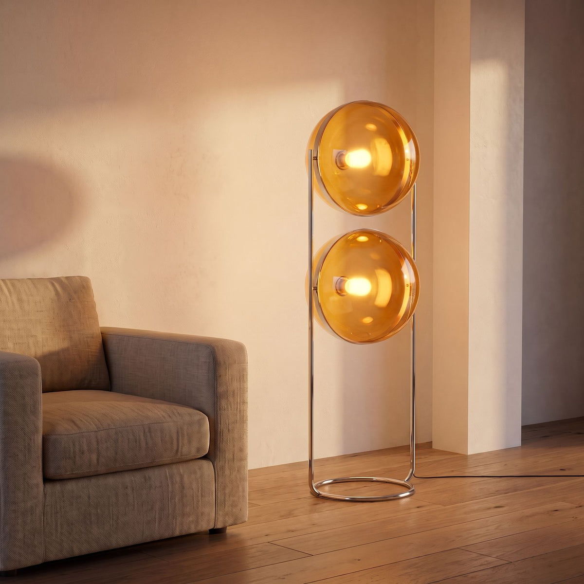 Chrome Ring Acrylic Double Globe Floor Lamp with amber shades beside an armchair in a living room corner
