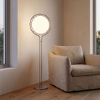 Chrome Ring Acrylic Globe Floor Lamp beside an armchair in a living room corner