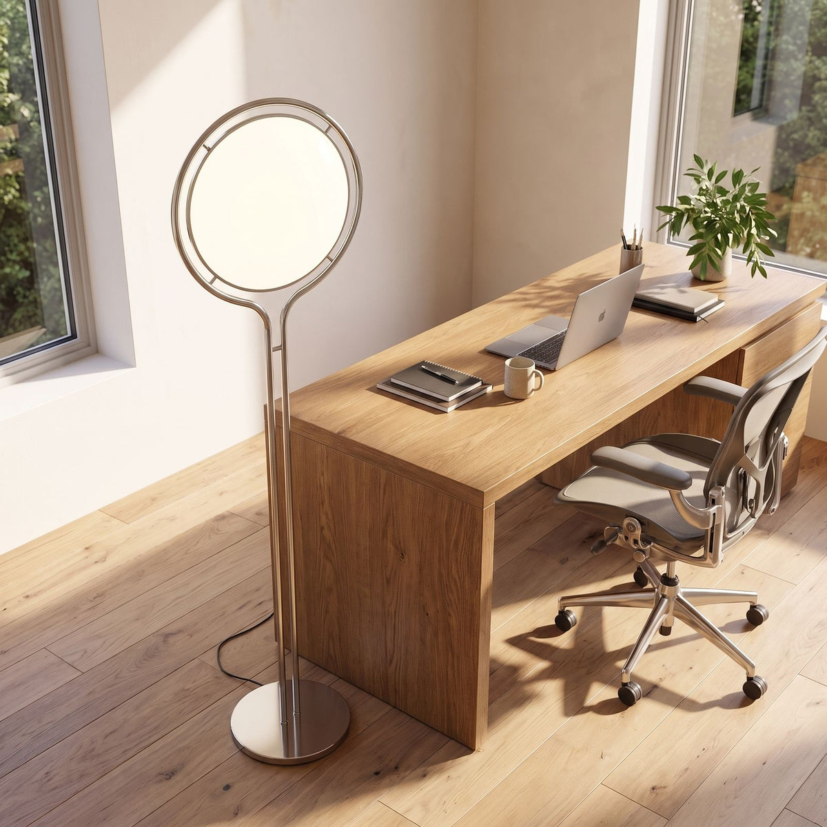 Chrome ring acrylic globe floor lamp beside a home office desk in daylight
