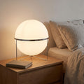 Chrome Ring Acrylic Globe Table Lamp on a bedside table