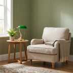 Classic Bankers Table Lamp with green shade and gold base beside an armchair