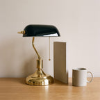 Classic Bankers Table Lamp beside an A4 notebook and a mug, showing its size
