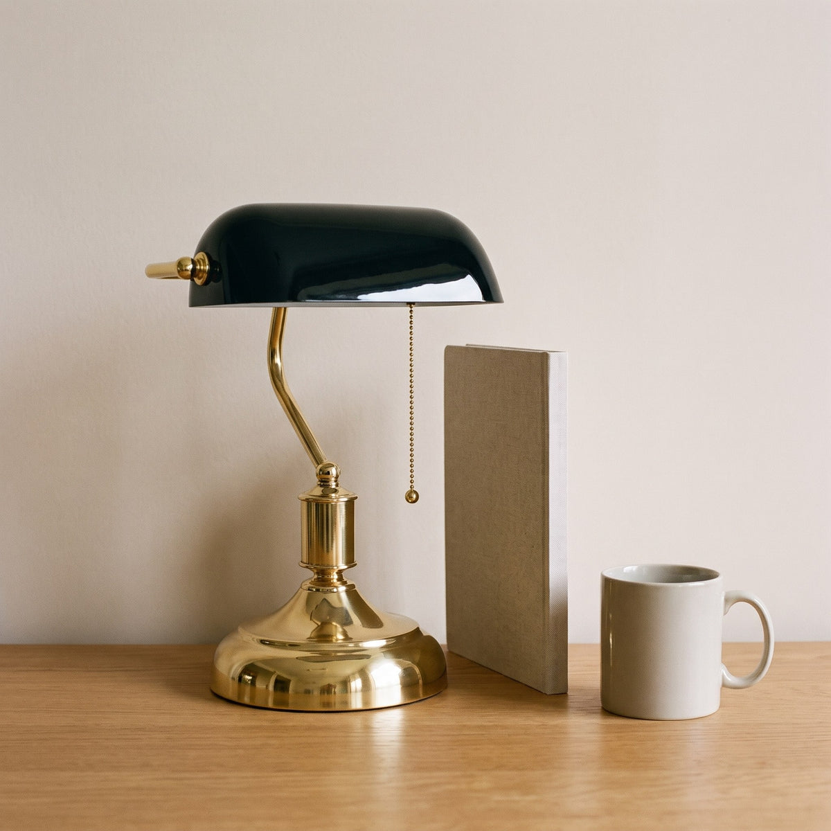 Classic Bankers Table Lamp beside an A4 notebook and a mug, showing its size