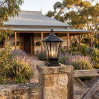 Classic Octagonal Glass Lantern Solar Post Light on a gate pillar at the front entrance at golden hour