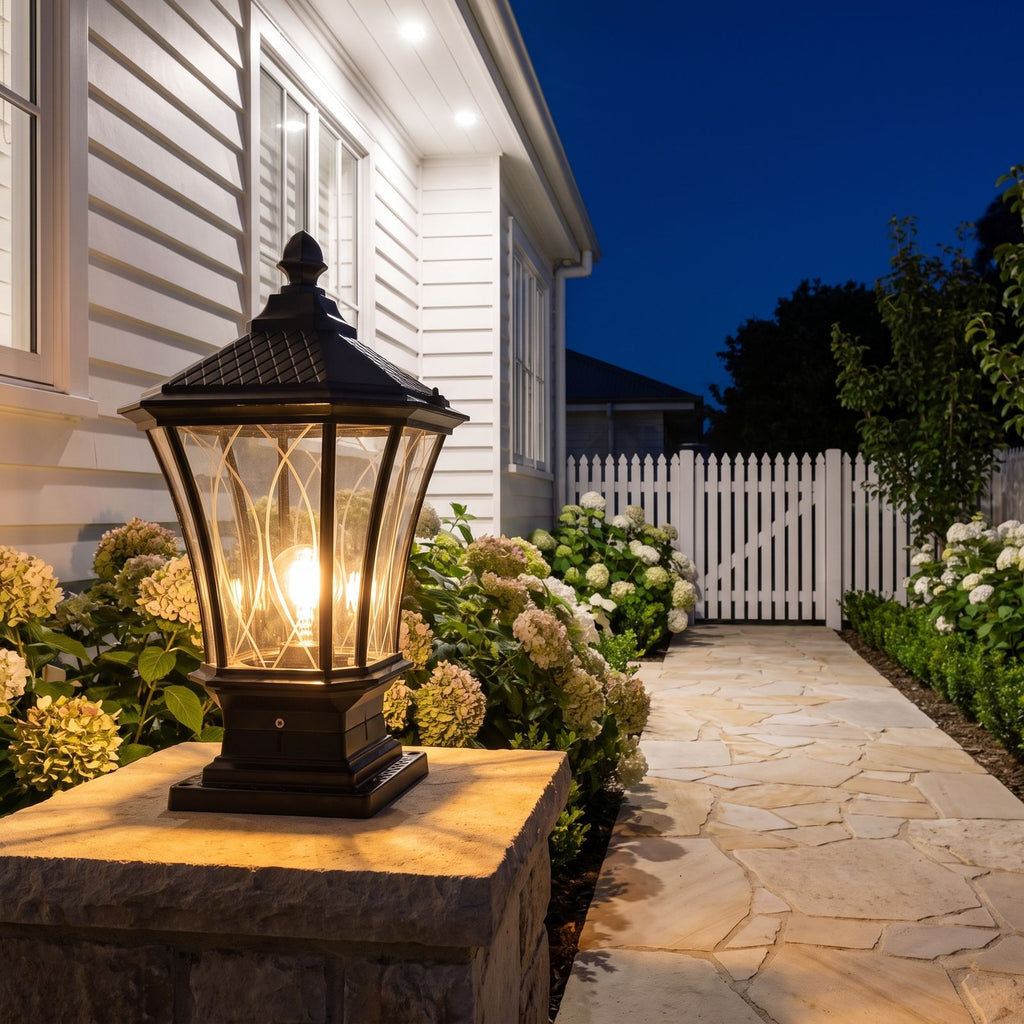 Classic Octagonal Glass Lantern Solar Post Light on a garden wall pillar at night