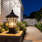 Classic Octagonal Glass Lantern Solar Post Light on a garden wall pillar at night
