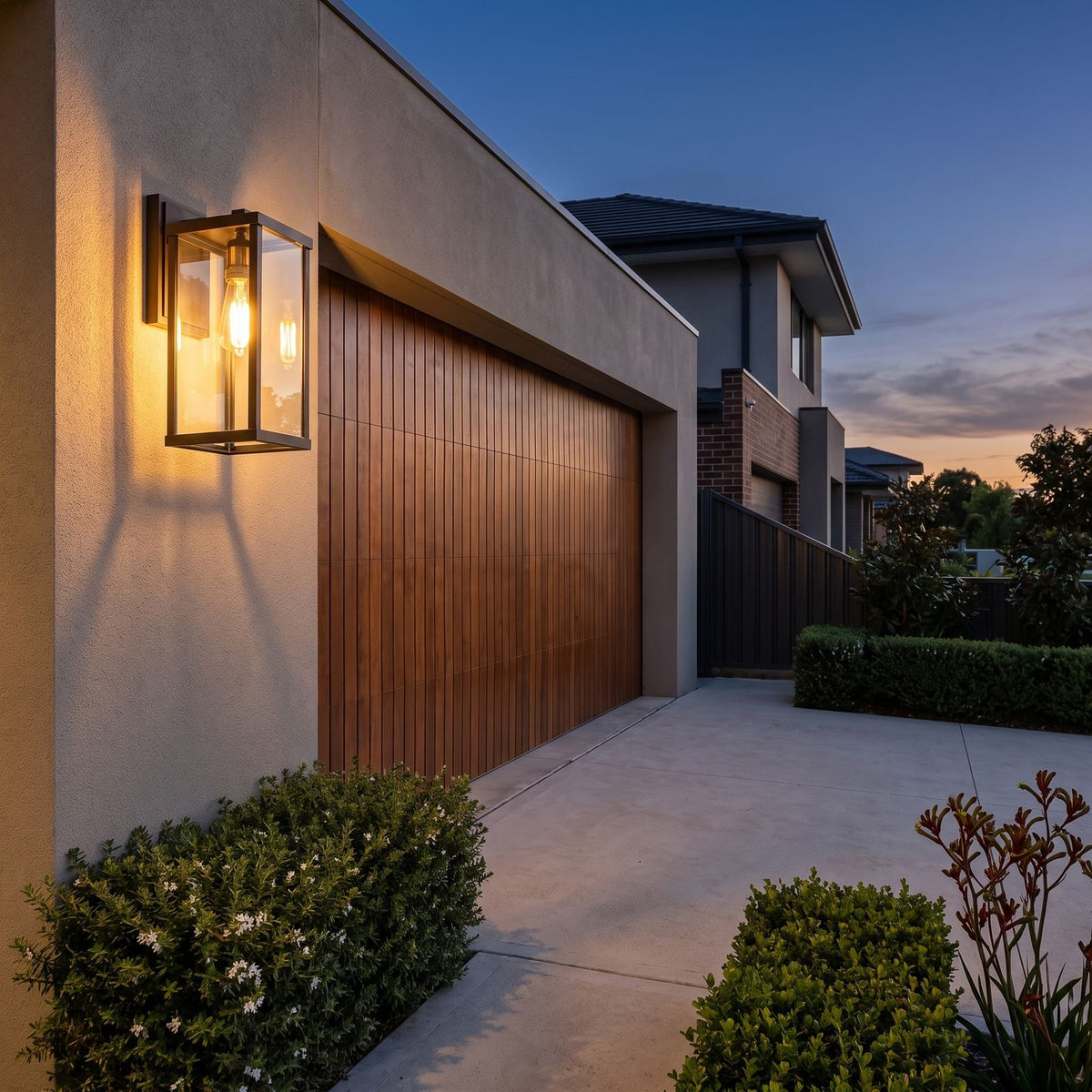 Clear Glass Lantern Outdoor Wall Light beside a timber garage door