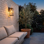 Clear Glass Lantern Outdoor Wall Light above a courtyard bench