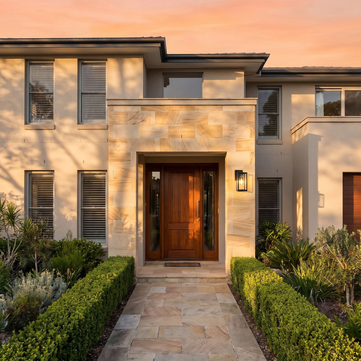Black Box Lantern Outdoor Wall Light beside the timber front door of a classic sandstone and rendered home at golden hour