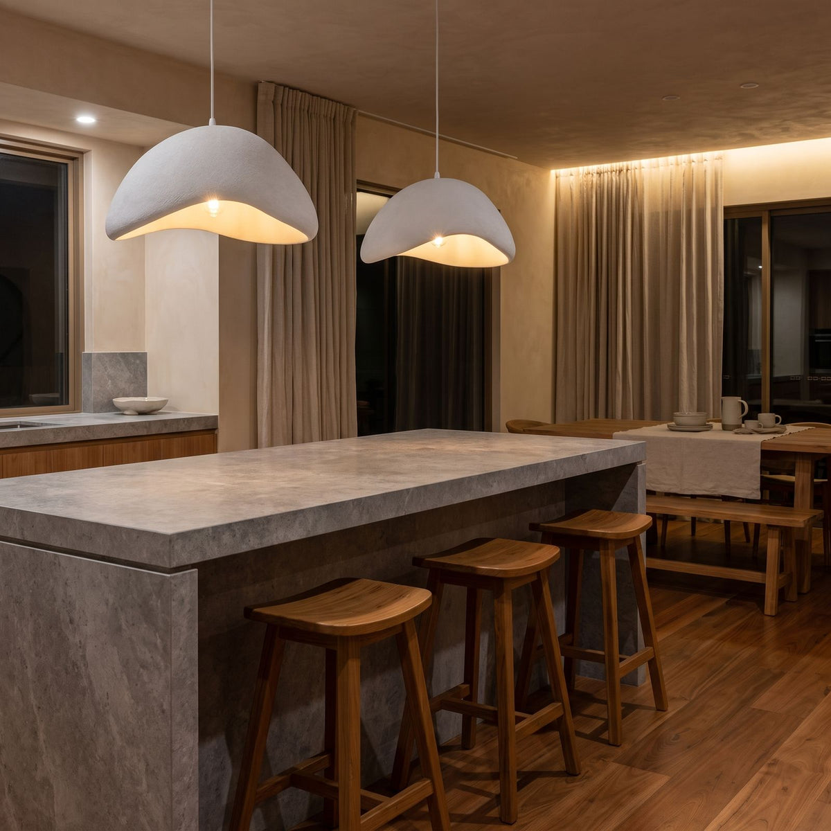 A pair of Cloud Shaped Japandi Pendant Lights over a stone kitchen island