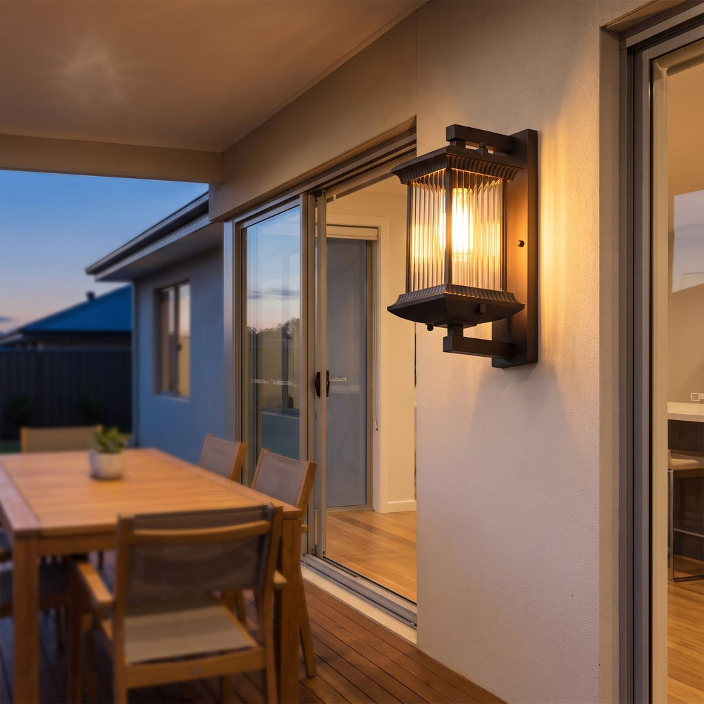 Fluted glass outdoor wall lantern on a covered alfresco patio wall at dusk