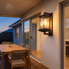 Fluted glass outdoor wall lantern on a covered alfresco patio wall at dusk