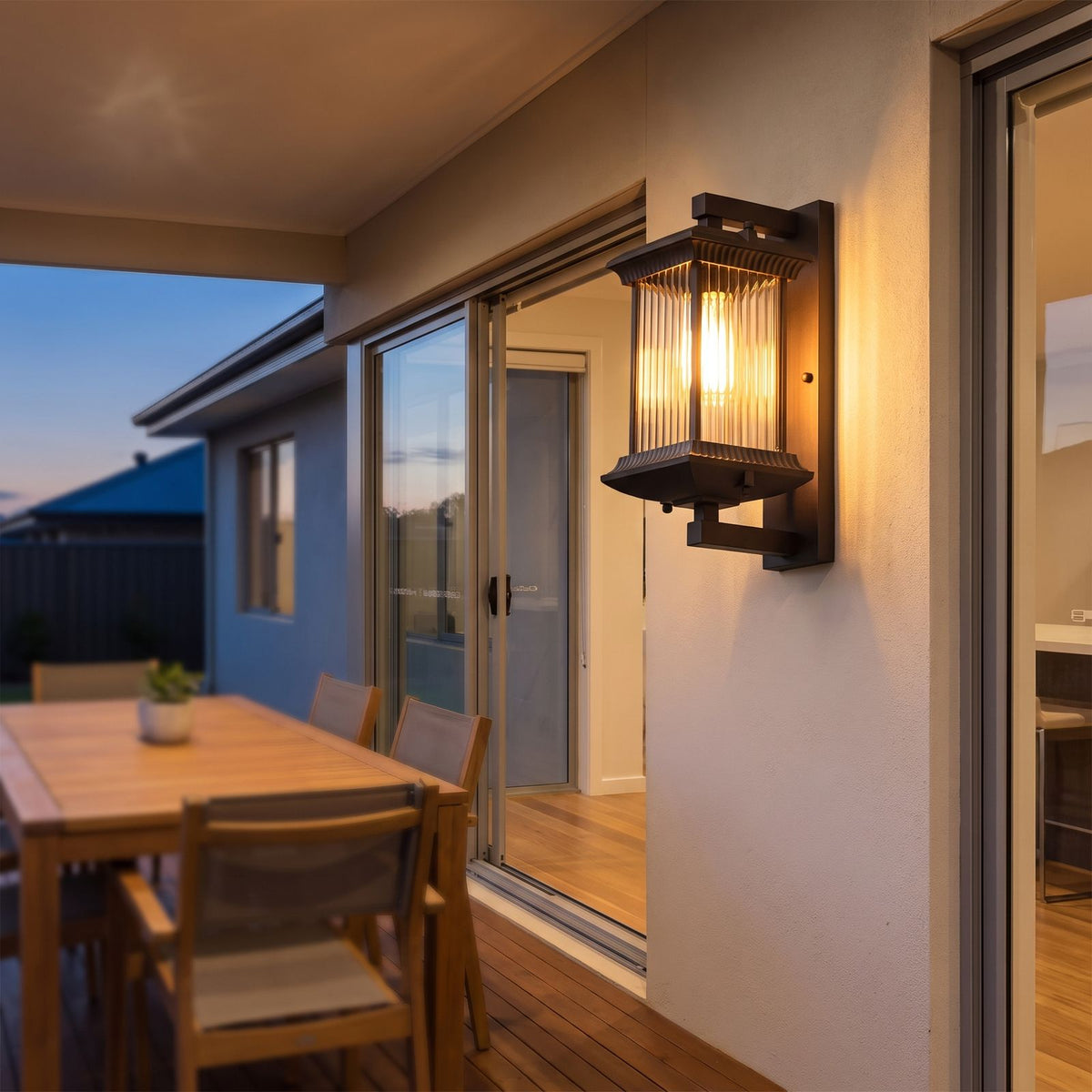 Fluted glass outdoor wall lantern on a covered alfresco patio wall at dusk