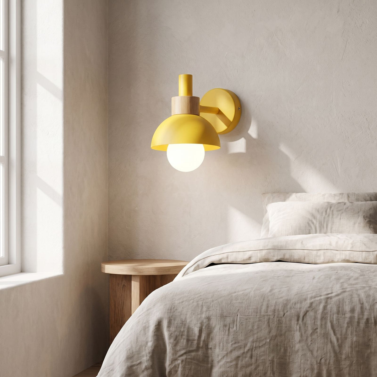 Coloured Matte Iron Cylinder Wall Light on a bedroom wall beside the bed
