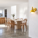 Coloured Matte Iron Cylinder Wall Light on a dining room wall