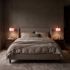 Pair of Colourful Two-Tone Glass Drum Pendant Lights in pink glass hanging either side of a bed above the bedside tables in a bedroom at night