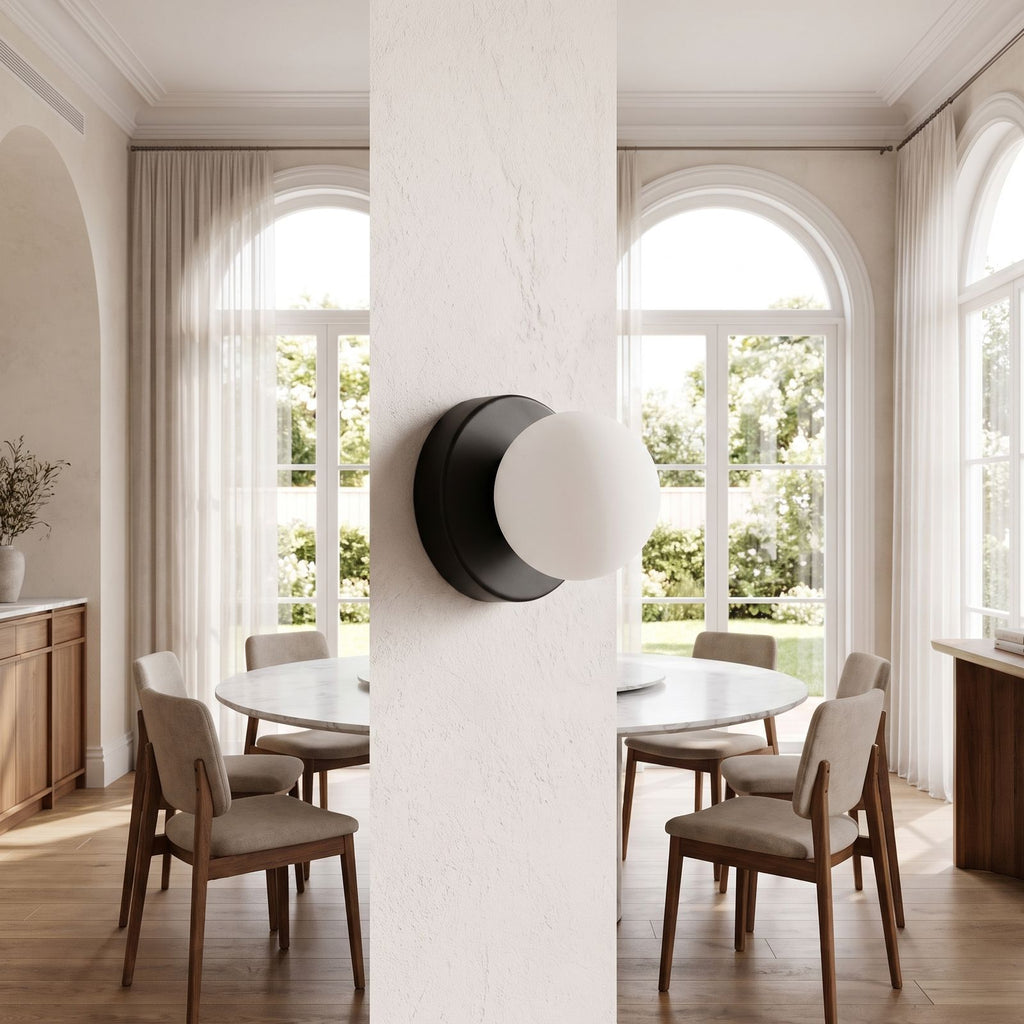 Compact Rounded Glass and Iron Wall Light on a dining room wall