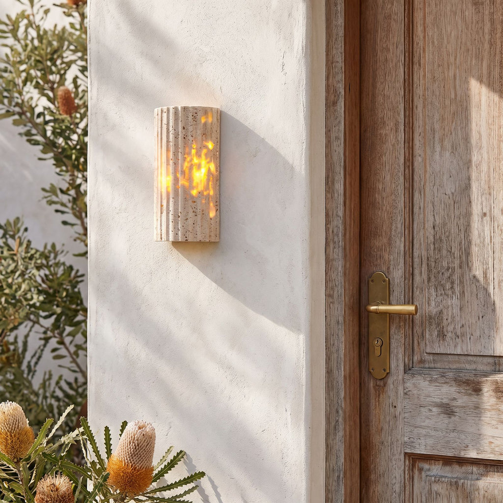 Compact Yellow Travertine Up Down Outdoor Wall Light beside a timber front door