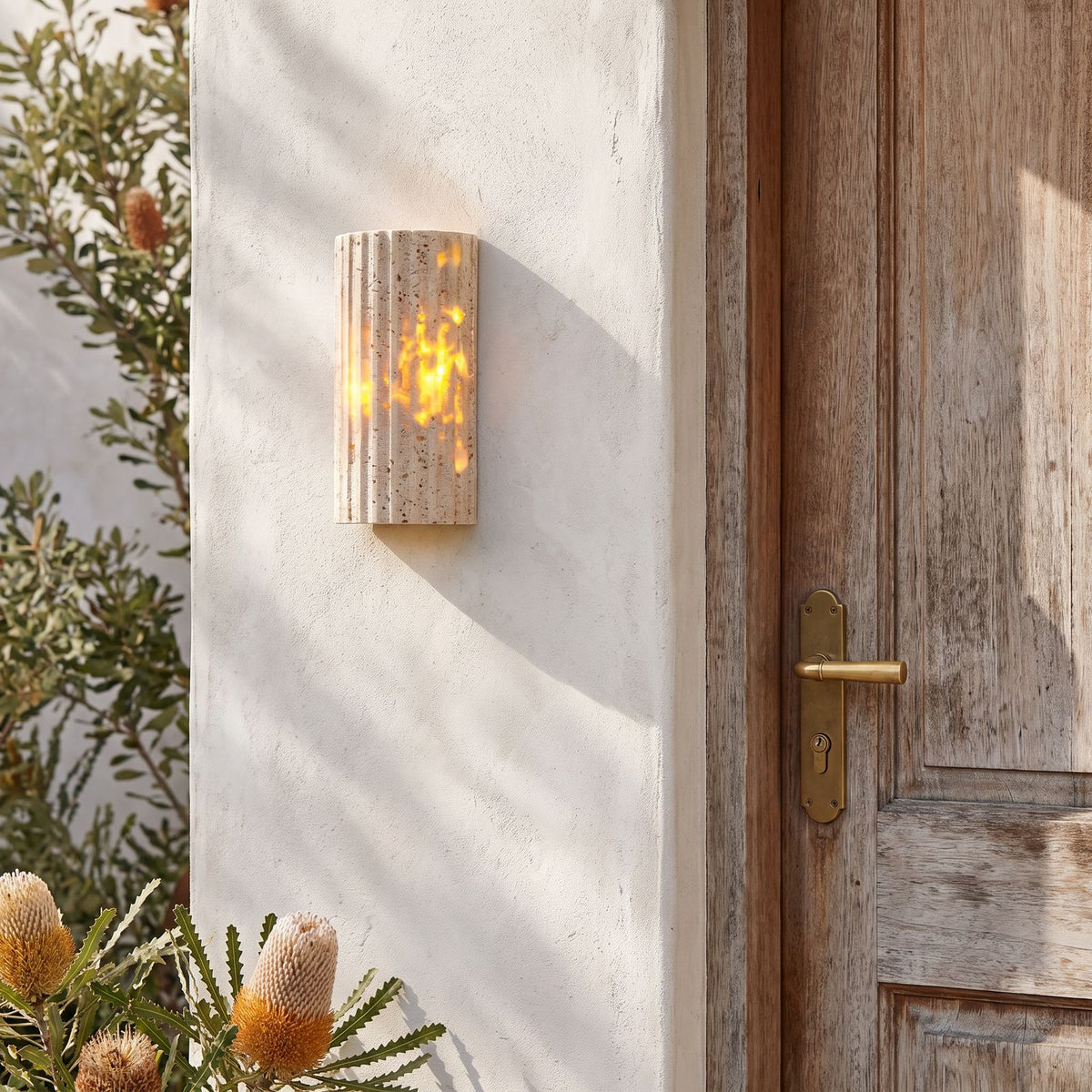 Compact Yellow Travertine Up Down Outdoor Wall Light beside a timber front door