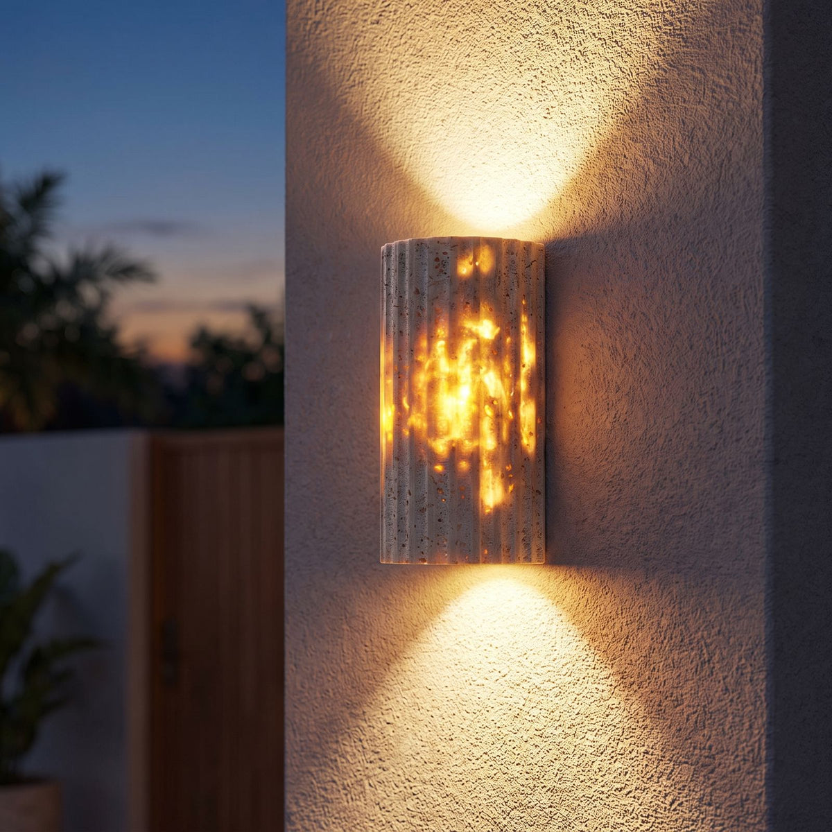 Compact Yellow Travertine Up Down Outdoor Wall Light on a porch wall at dusk