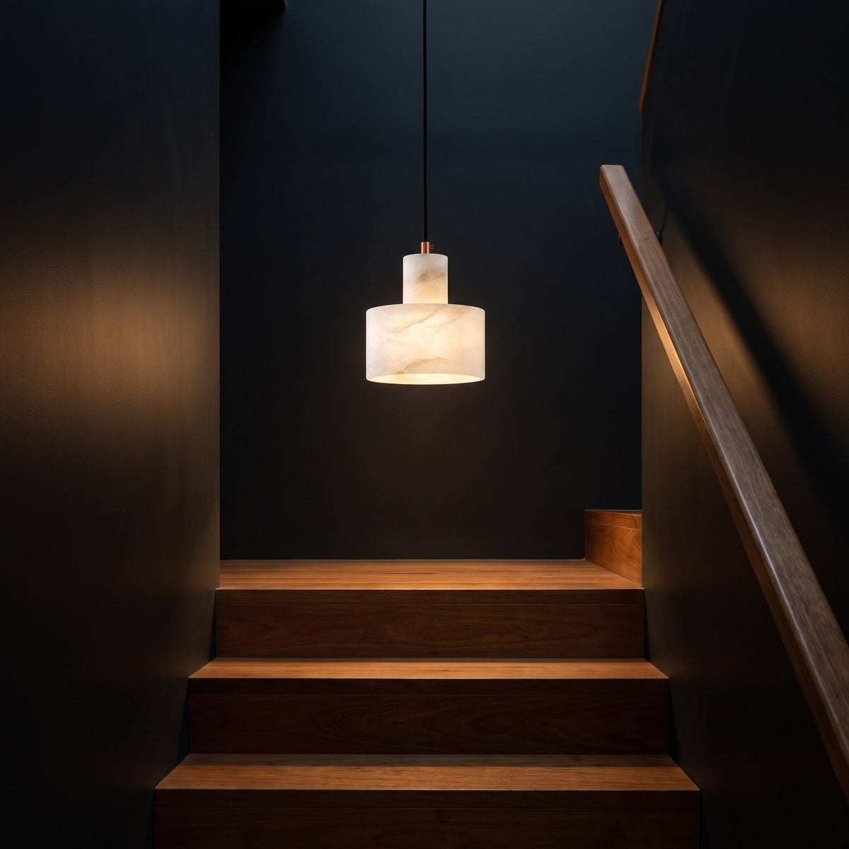 Copper and Alabaster Cylinder Pendant Light in a stairwell at night