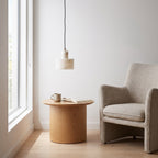 Copper and Alabaster Cylinder Pendant Light above a side table in a reading corner