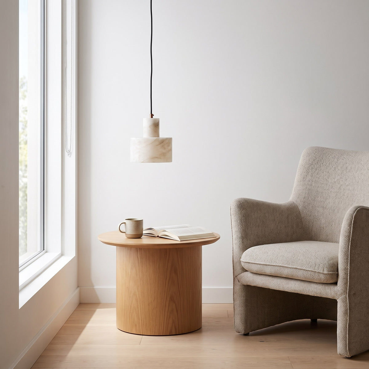 Copper and Alabaster Cylinder Pendant Light above a side table in a reading corner