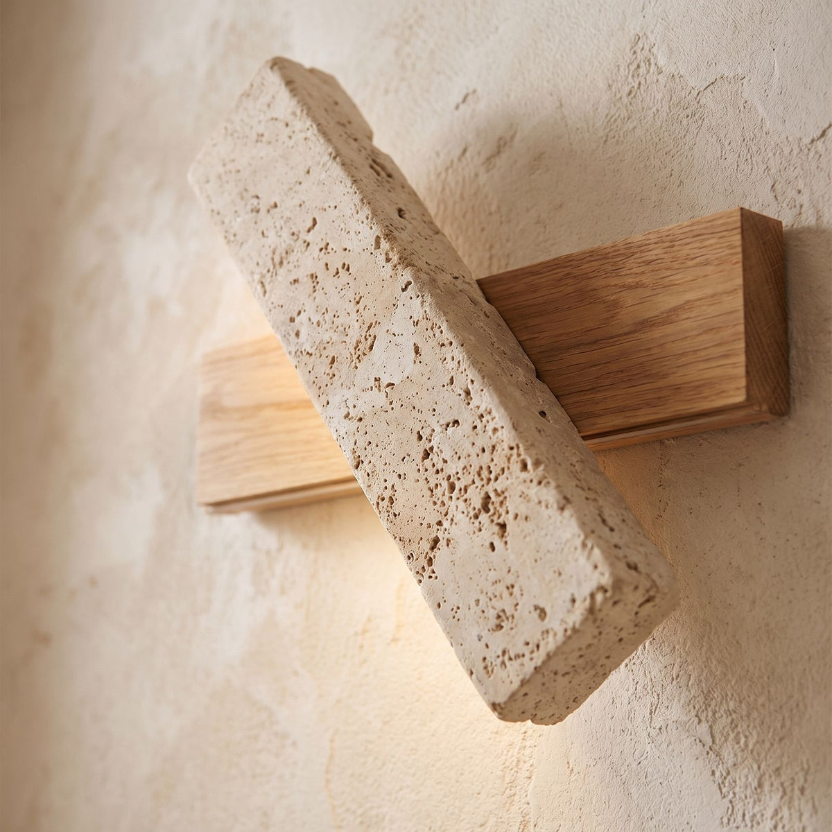 Crossed Travertine and Wood Rotating Wall Light, close view at 45 degrees on a plaster wall