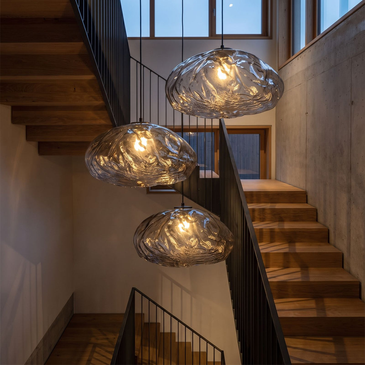 Crumpled Glass Cloud Pendant Light in a cluster of three in a stairwell