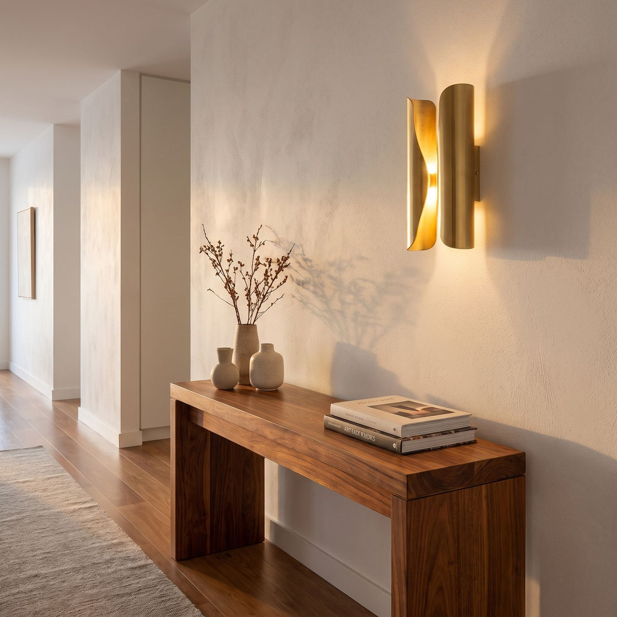 Curled Brass Panel Wall Sconce in a hallway above a timber console
