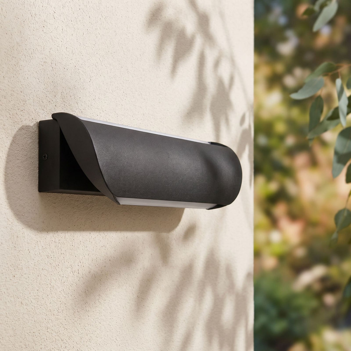 Curved Acrylic LED Outdoor Wall Light on a rendered wall, angled close view