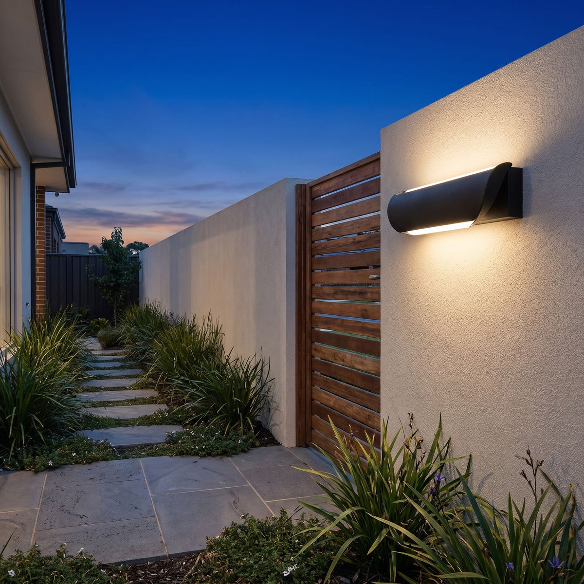 Curved Acrylic LED Outdoor Wall Light on a rendered wall beside a side gate at dusk