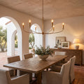Curved Arm Antique Gold Iron Candle Chandelier above a dining table at golden hour