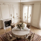 Curved Arm Antique Gold Iron Candle Chandelier in a styled bedroom in soft daylight