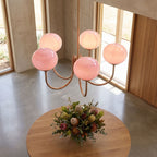 Curved arm opal glass globe chandelier in an entry hall in daylight