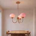 Curved Arm Opal Glass Mushroom Globe Pendant Light with three heads above a dining table