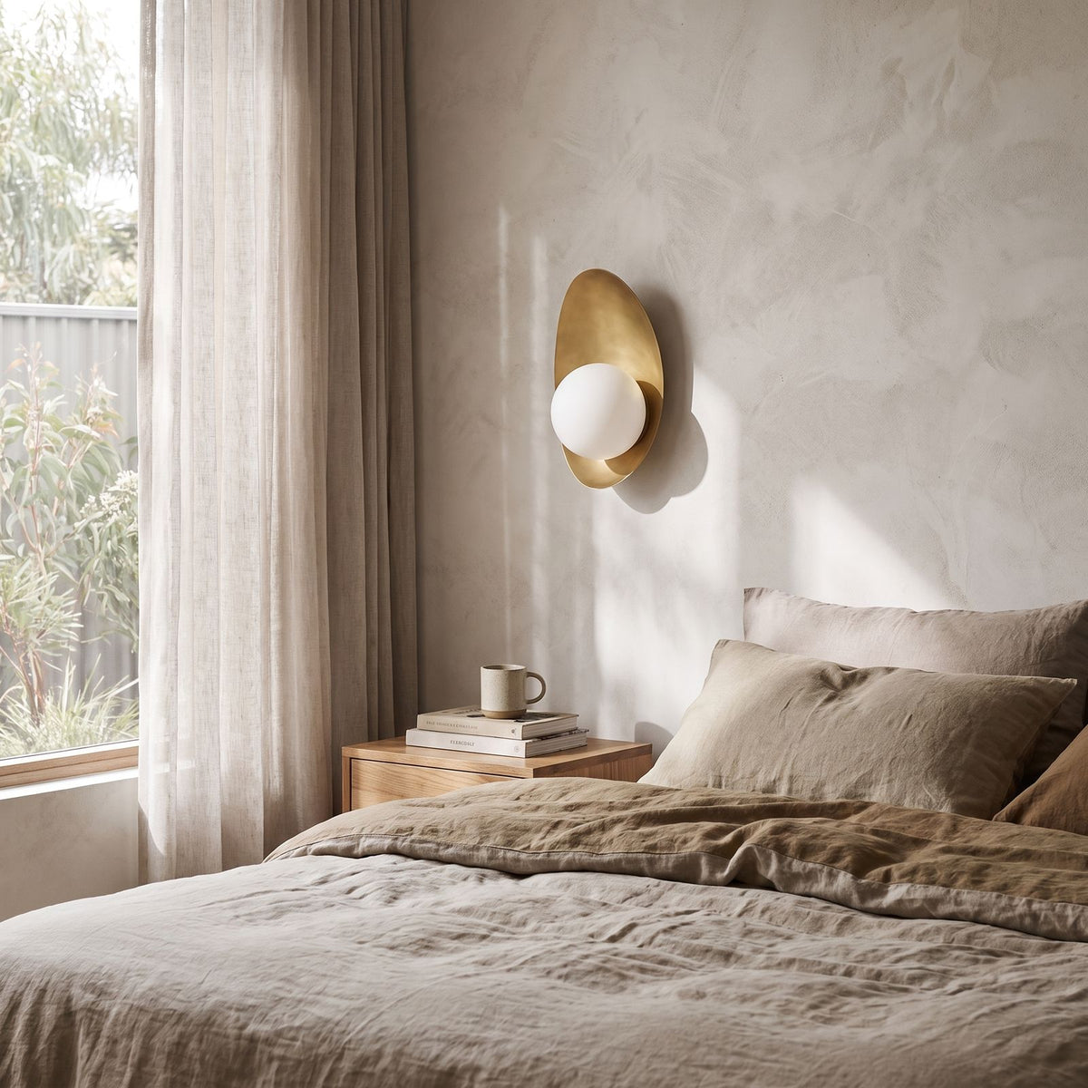 Curved Gold Shield Opal Globe Wall Light on a bedroom wall beside the bed