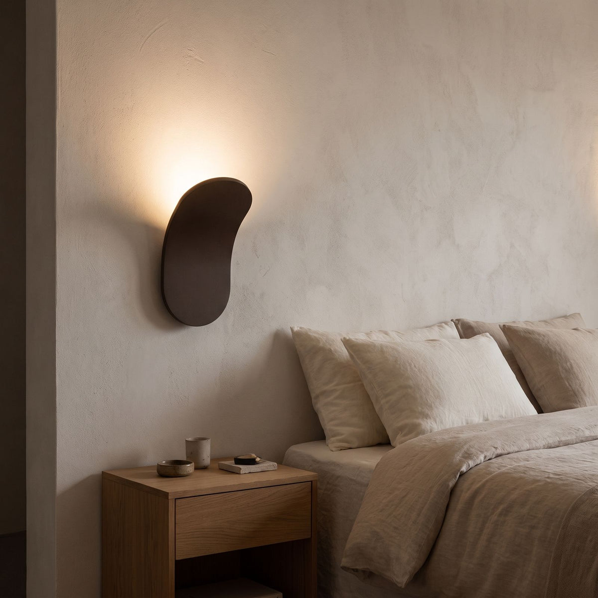 Curved Metal Paddle Indirect LED Wall Light beside a bed