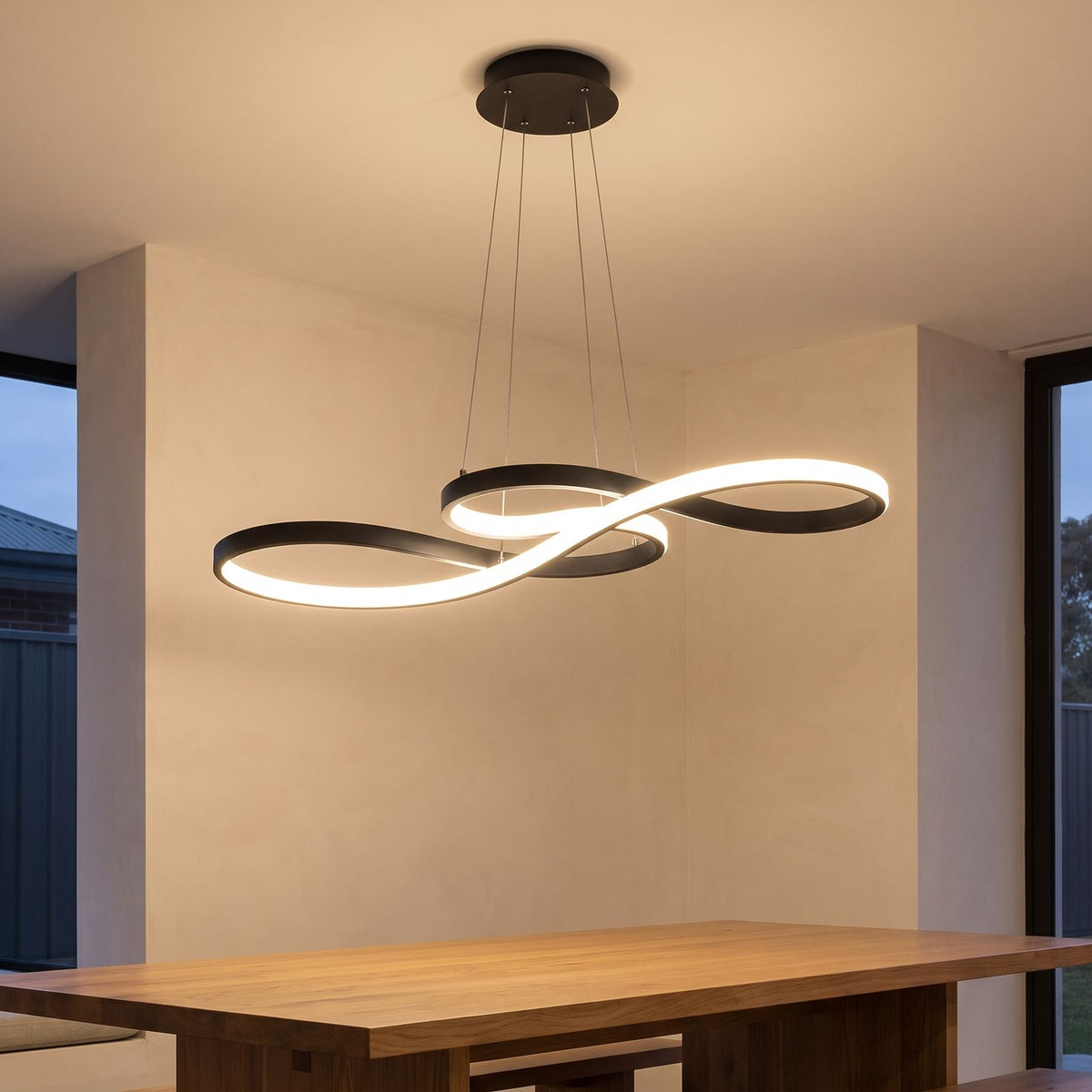 Curved Ribbon Aluminium LED Pendant Light above a dining table
