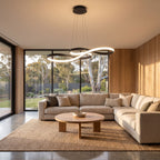 Curved ribbon aluminium LED pendant light in a wide living room view
