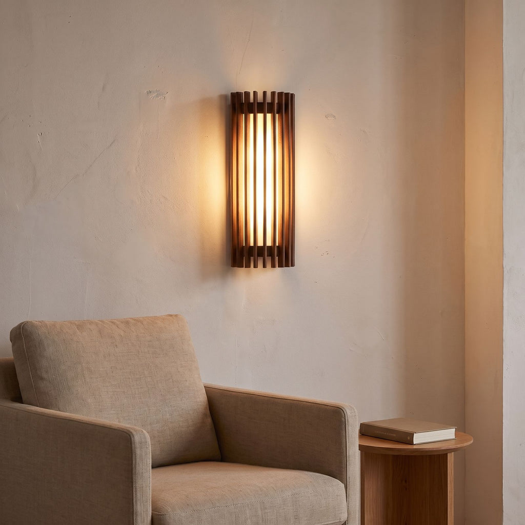 Curved slatted wood wall sconce above an armchair in a reading corner