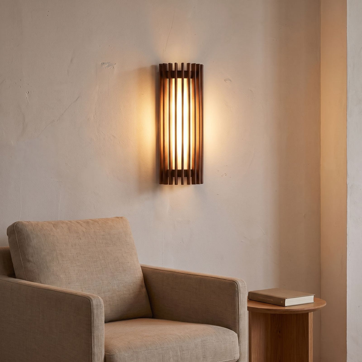 Curved slatted wood wall sconce above an armchair in a reading corner