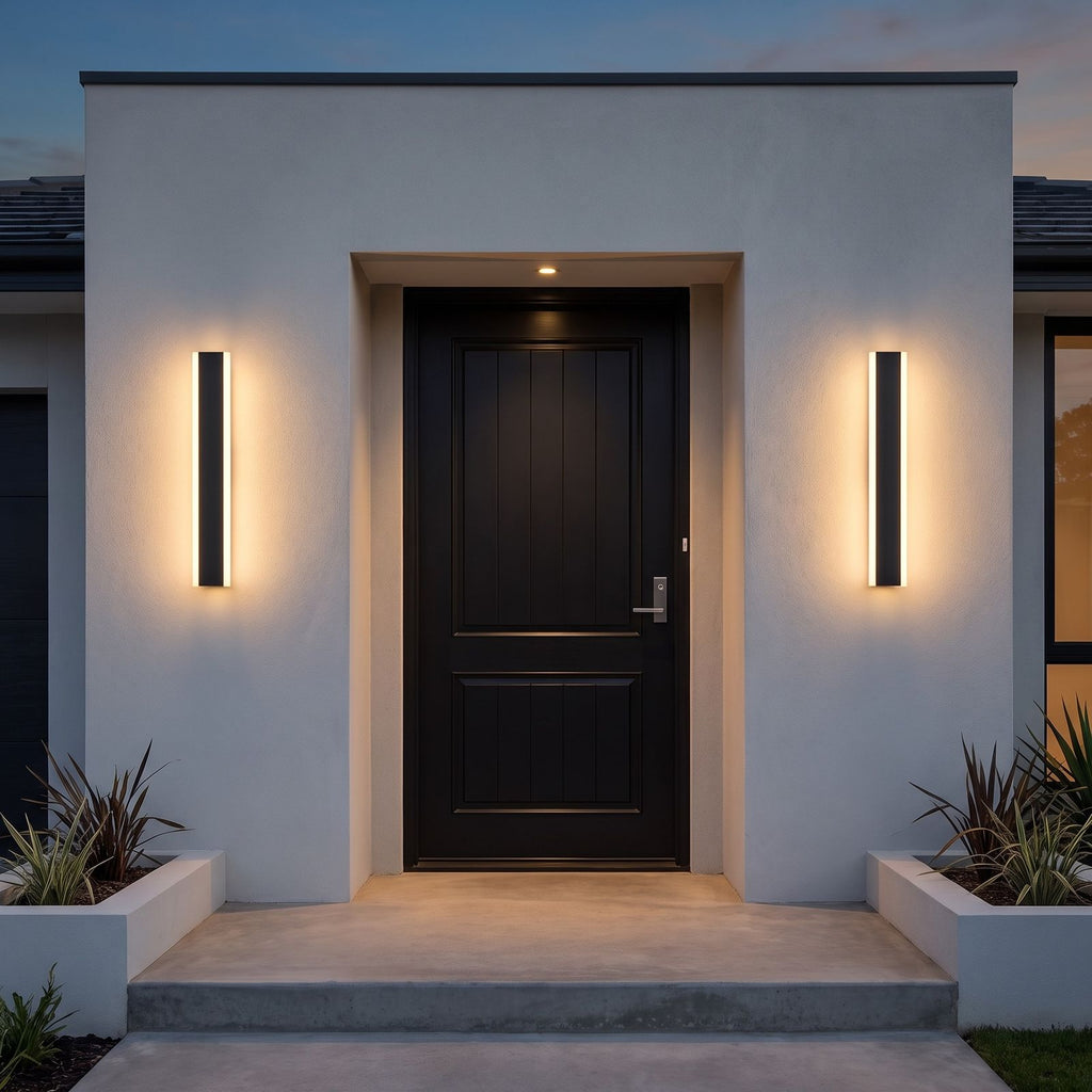 Pair of linear LED wall lights framing a black front door at dusk